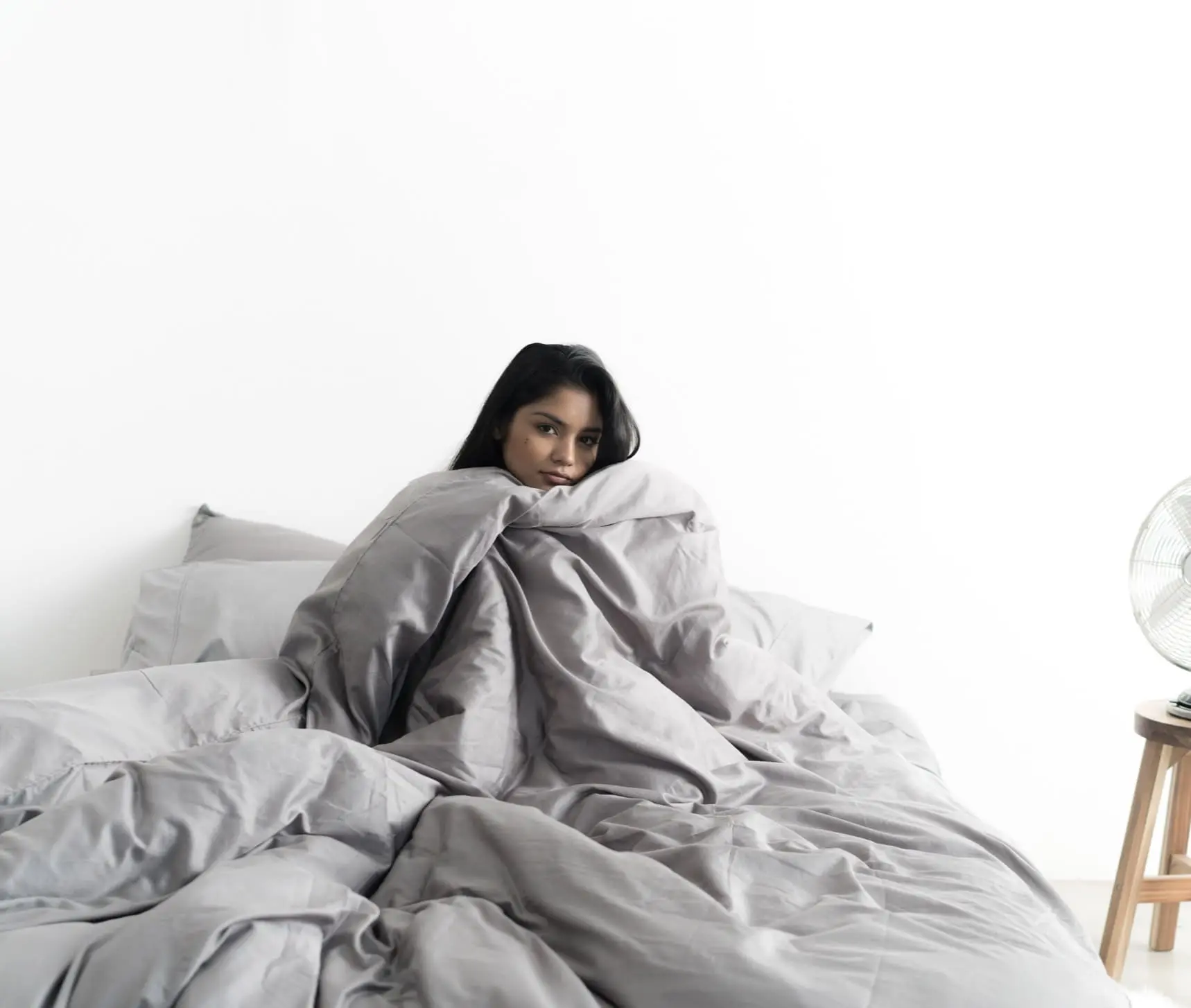 A woman is happy after sleeping on Miracle Sheets